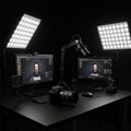 A video streaming setup featuring two computer monitors displaying editing software, Royalty Free Stock Photo