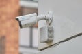 Video surveillance camera on the building, monitoring the security of a window residential house - Moscow, Russia, August 01, 2021