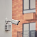 Video surveillance camera on the building, monitoring the security of a window residential house