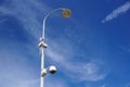 Video surveillance on modern street lamp over blue sky Royalty Free Stock Photo