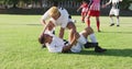 Video of two diverse footballers helping fouled teammate