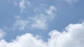 Video of white fluffy clouds moving on blue sky on sunny summer day. Sound of birds chirp and city noise