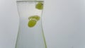 Video of white wine grapes falling into carafe with sparkling water. Wine grapes moving up and down as they are buoyed by air