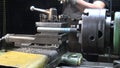 Video of a man working with metal details on a lathe