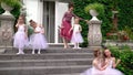 The teacher of the ballet does warm-up on a porch of ballet school. Ballerinas do warm-up