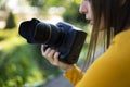 Videograph woman holding her reflex camera in the woods Royalty Free Stock Photo