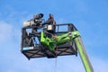 Videographer on crane basket