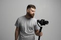 Videographer making a good footage using steadicam. Cameraman creator with a stabilizer in his hands takes a video on Royalty Free Stock Photo