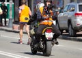 Videographer on a motorcycle records video marathon run