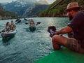 A videographer recording a group of friends kayaking together and exploring river canyons