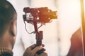 Videographer recording video with mirrorless digital camera on Gimbal