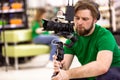 Videographer shooting a film or a television program in a studio with a professional camera, backstage Royalty Free Stock Photo