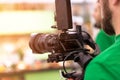 Videographer shooting a film or a television program in a studio with a professional camera, backstage Royalty Free Stock Photo