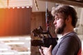 Videographer shooting a film or a television program in a studio with a professional camera, backstage Royalty Free Stock Photo