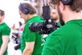 Videographer shooting a film or a television program in a studio with a professional camera, backstage Royalty Free Stock Photo