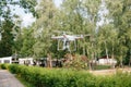 Videography wedding ceremony from the air a small spy quad copter scout drone flying through the trees in forest. Royalty Free Stock Photo