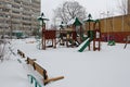 Children`s playground under snow after night snowstorm in the yard in Vidnoe Royalty Free Stock Photo