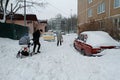 People walk through the snowdrifts after night snowstorm in the yard in Vidnoe Royalty Free Stock Photo