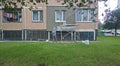 Builder worker plasters the facade of residential building in Vidnoe