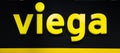 Viega company logo. Plastic yellow letters with lights on the black wall