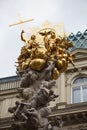 Golden sculpture on a stone plague column in Vienna