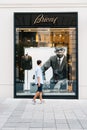 Young man in front of luxury fashion storefront