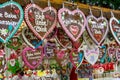 Vienna, Austria - 11.23.2019 : Christmas food sweets kiosk stand on a winter market with colorful gingerbread Lebkuchen hearts