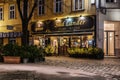 Christmas Street with Illuminated Cafe at Dusk