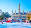 People enjoy skating on large ice rink on park of Rathausplatz in front of Vienna City Hall, Austria Royalty Free Stock Photo