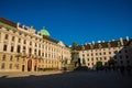 Vienna, Austria: Hofburg palace and panoramic square view, people walking and fiaker with white horses in Vienna, Austria Royalty Free Stock Photo