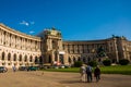 Vienna, Austria: Hofburg palace and panoramic square view, people walking and fiaker with white horses in Vienna, Austria Royalty Free Stock Photo