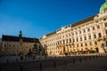 Vienna, Austria: Hofburg palace and panoramic square view, people walking and fiaker with white horses in Vienna, Austria Royalty Free Stock Photo