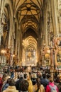 Inside view of Stephansdom St Stephan`s Cathedral. Church full of tourists during a mass. Royalty Free Stock Photo