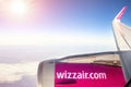 Vienna, Austria - January 03, 2020: Wizzair lowcost economy flight company airbus plane flying over clouds with bright