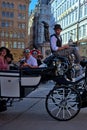 A group of delighted, open-mouthed tourists sightseeing in the historic center of Vienna.