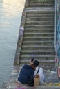 Lovers on the stairs on the Danube Canal Embankment in Vienna