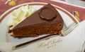 VIENNA, AUSTRIA - JUNE 01. 2016: Original Sacher Torte with cream and fork at Sacher Cafe Royalty Free Stock Photo