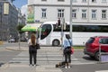 People at a pedestrian crossing waiting for a green light