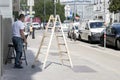 transforming roads, unyielding determination a man and a ladder working tirelessly