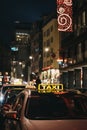 Close up of a sign on yellow taxi on a street in Vienna, Austria, at night