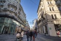 Panorama of Karntner street with people shopping in stores around.