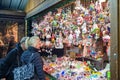 People buy Christmas baubles, toys and souvenirs at traditional Christmas market in front of