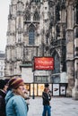 People walking past sign to Christmas market stall near St. Step Royalty Free Stock Photo