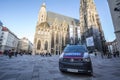 Austrian police car from the Bundespolizei, or polizei, patrolling and guarding Stephansplatz and the Domkirche catholic cathedral