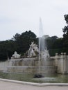 Wide angle shot of a fountain next to a statue in Schonbrunner Schloss Park in Vienna, Austria