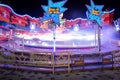 Lights of ride in motion in amusement park at night Royalty Free Stock Photo