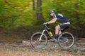 Mountainbiker rides through forest stream