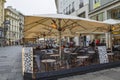 Vienna, Austria - October 2019: Outdoor electric heating infrared lamps under umbrella in street cafe in cold autumn season