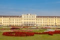 Schonbrunn palace in Vienna with colorful flowers and lots of tourists