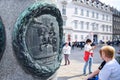 VIENNA, AUSTRIA - OKTOBER 10, 2018:Vintage engraving on a post with king on horse in center with tourists on background